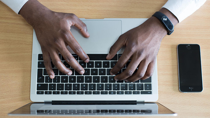 Man on his laptop Googling What is affiliate marketing and how does it work